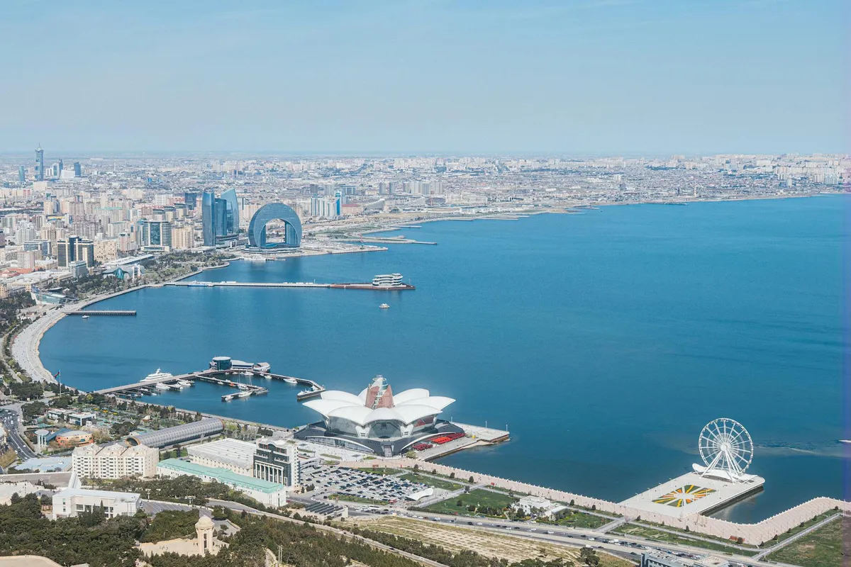 Stunning aerial photo of Baku's modern skyline and waterfront in daylight, showcasing architectural landmarks.