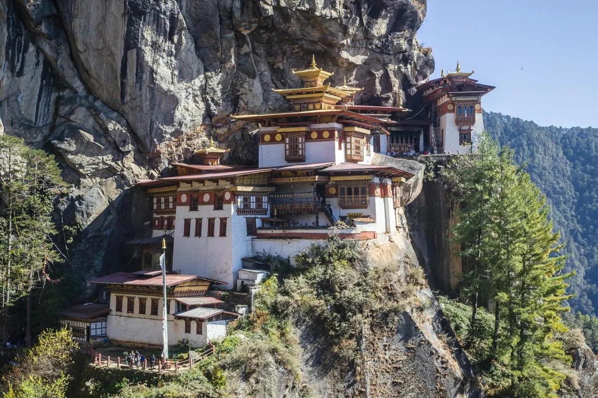 Stunning view of Tiger's Nest Monastery perched on a cliff in Bhutan's mountains.