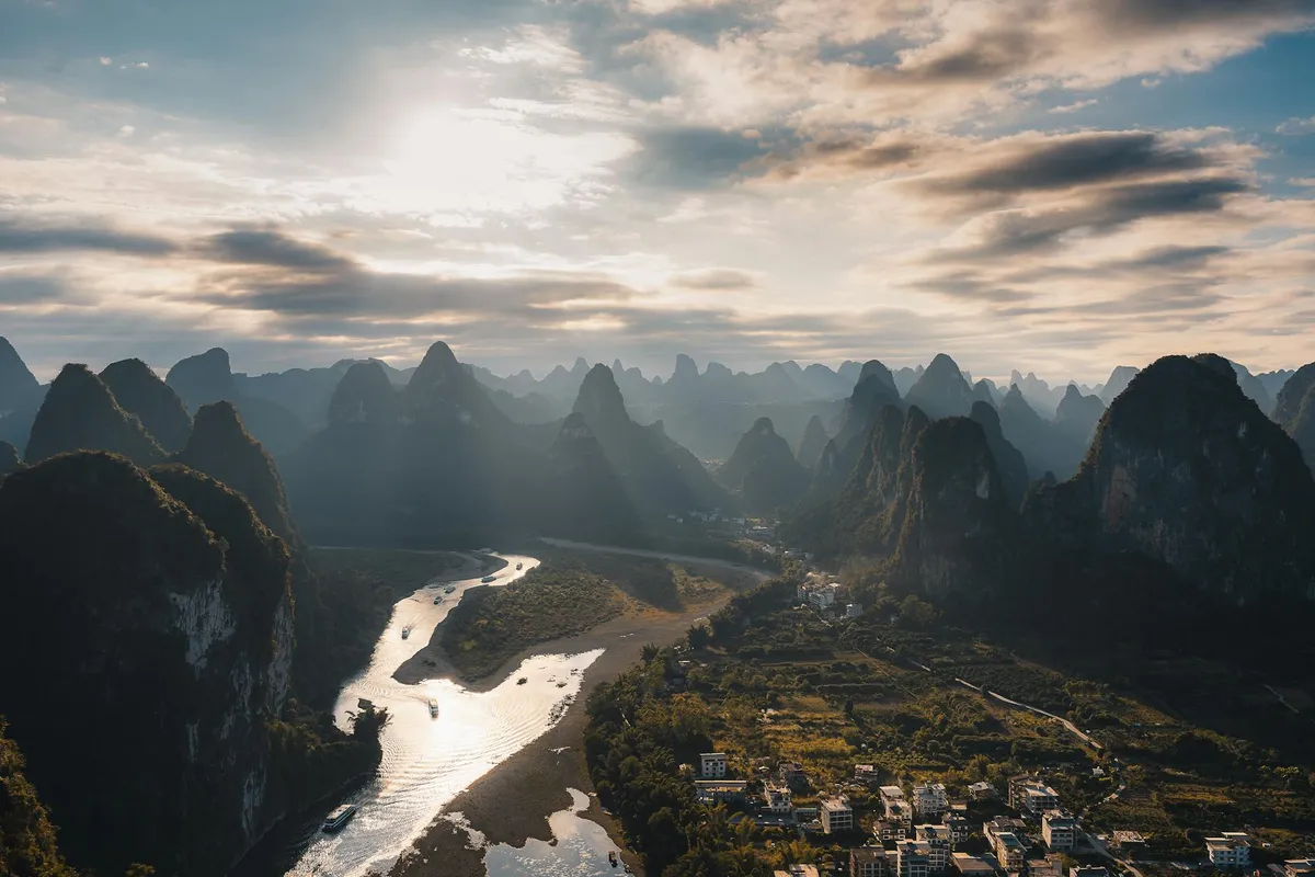 Stunning aerial view of the Li River and karst mountains in Guilin, Guangxi, China at sunset.