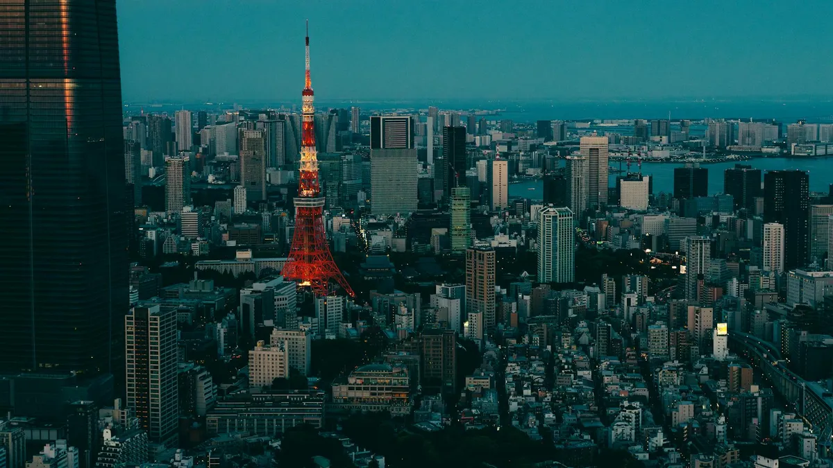 A breathtaking twilight cityscape of Tokyo with the iconic Tokyo Tower illuminated.