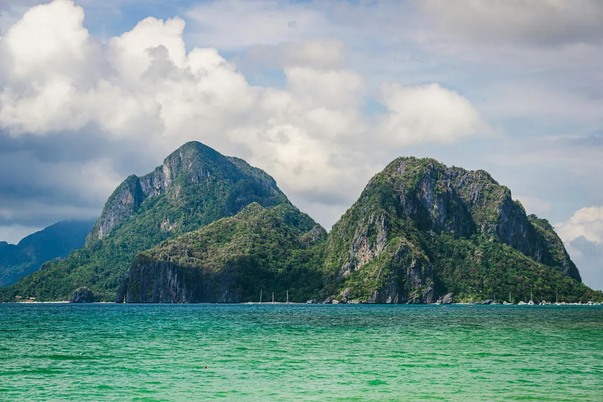 Breathtaking view of El Nido's limestone cliffs surrounded by blue ocean.
