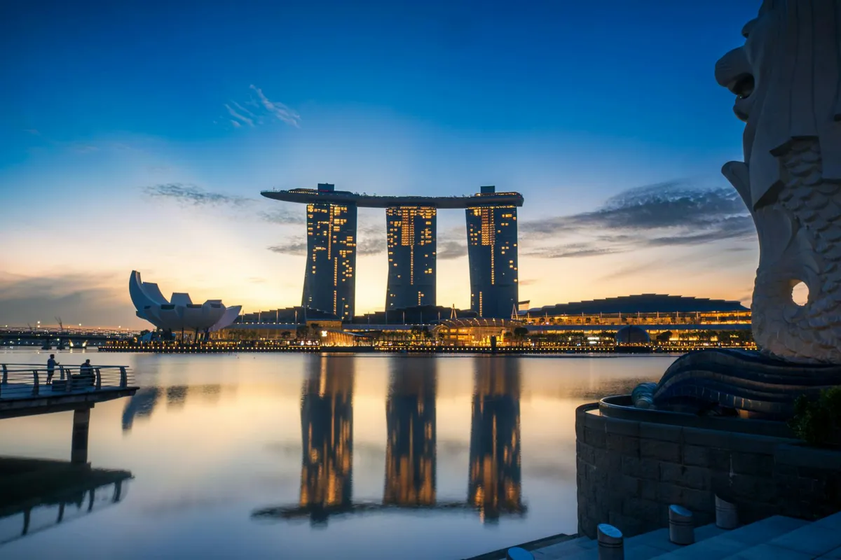 Stunning sunrise view of Marina Bay Sands and Merlion in Singapore.