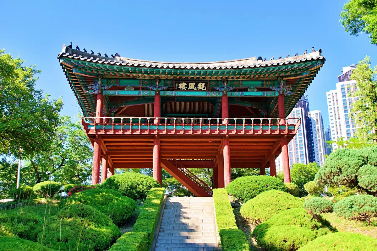 Beautiful Korean pavilion in Daegu with modern city backdrop, captured on a sunny day.