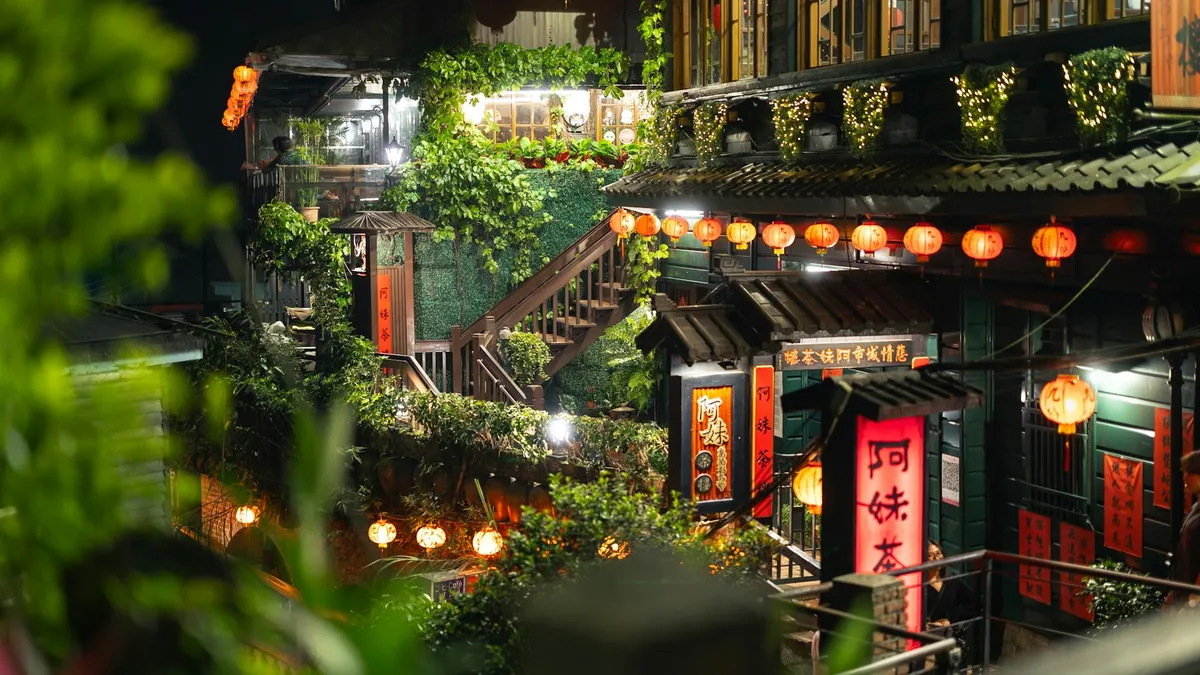 A beautifully illuminated street scene in Jiufen, Taiwan, showcasing traditional architecture and vibrant lanterns.