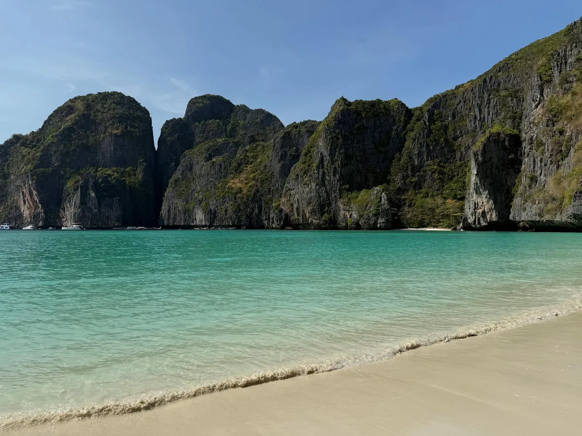 Stunning view of Maya Bay with turquoise waters and limestone cliffs in Thailand.