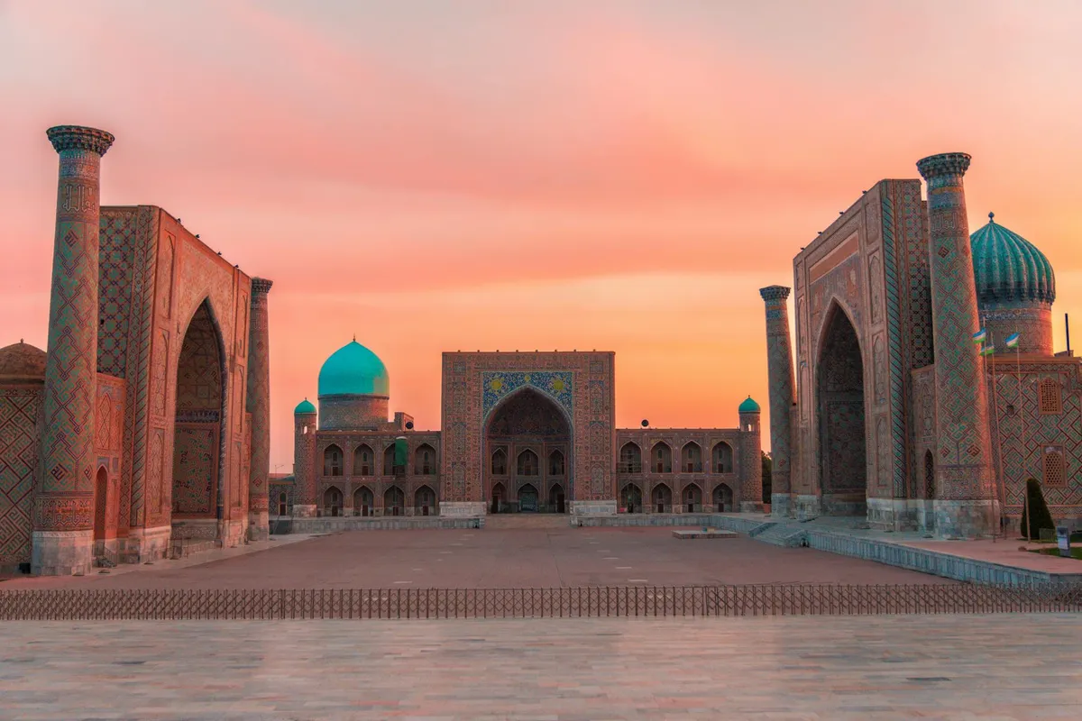 A stunning sunset view of Registan Square, showcasing its historic architecture in Samarkand, Uzbekistan.