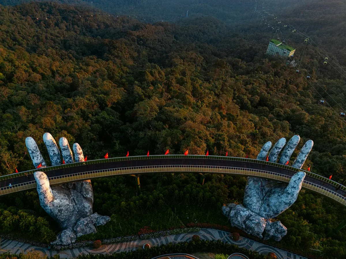 A breathtaking aerial shot of the iconic Golden Bridge held by giant stone hands in Vietnam.