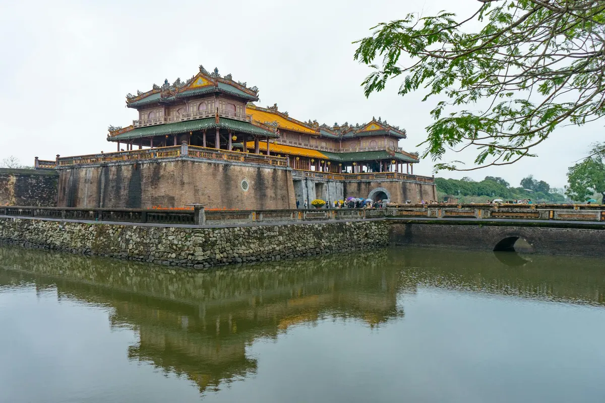 A serene view of the Imperial City gate reflected in the moat, Huế, Vietnam.