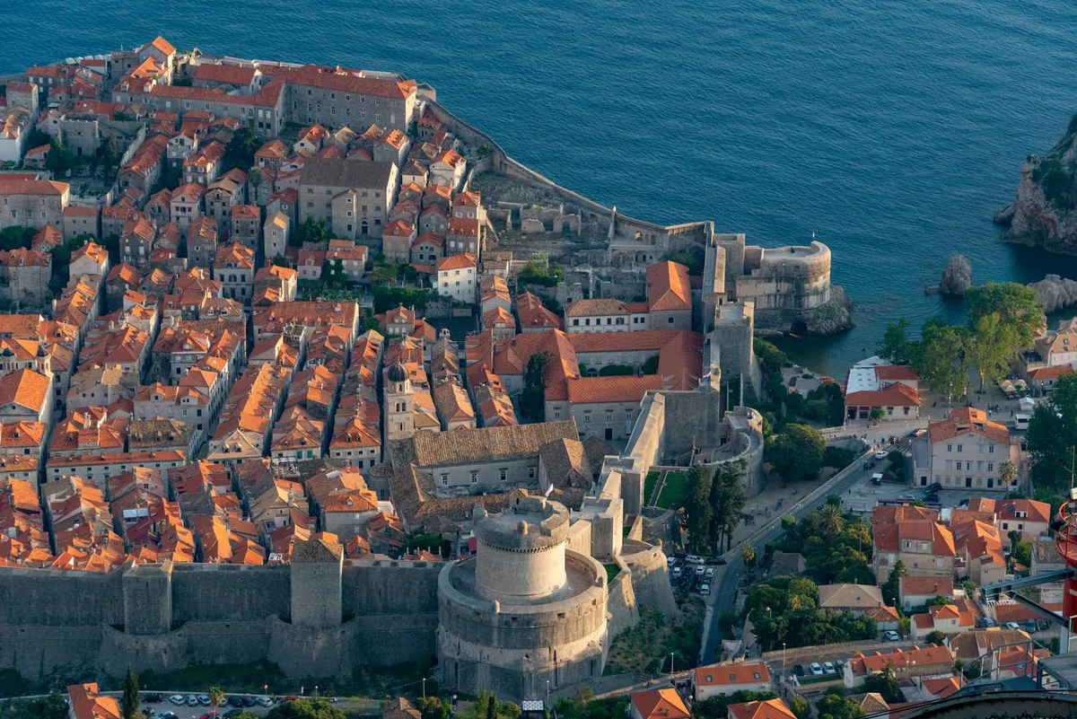 Stunning aerial view of the historic Dubrovnik Old Town and its city walls by the Adriatic Sea.