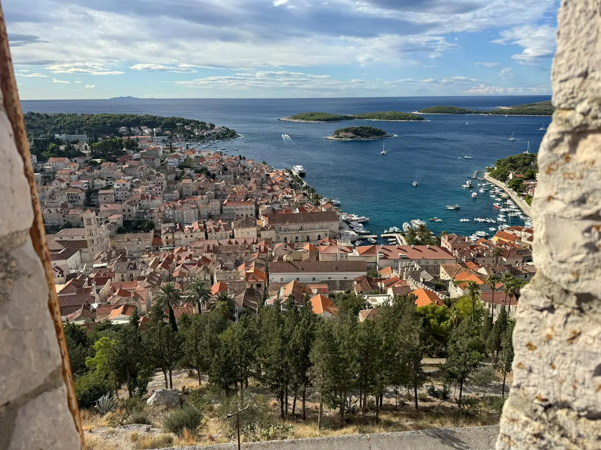 Aerial view of Hvar Town overlooking the Adriatic Sea with islands and yachts.