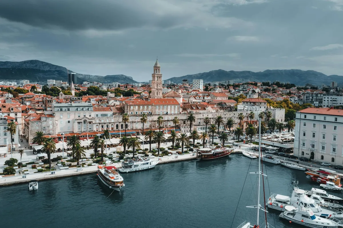 Stunning aerial view of Split's waterfront showcasing boats, buildings, and iconic bell tower.