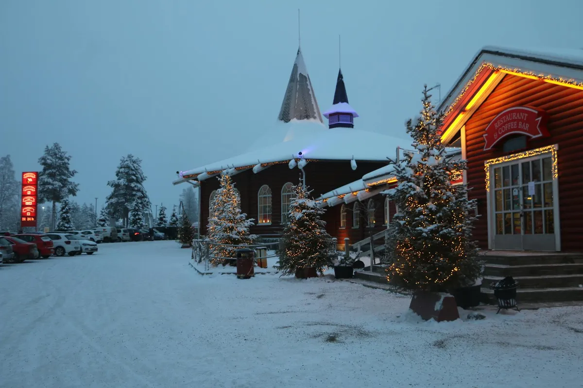 A festive twilight scene of Santa Claus Village in snowy Rovaniemi, Lapland, Finland.