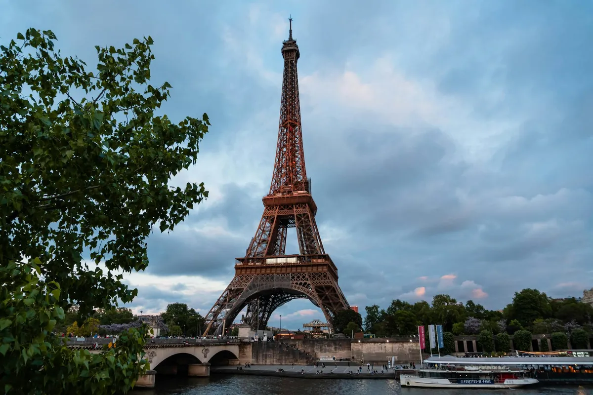 Scenic view of the Eiffel Tower and Seine River during sunset in Paris, France.