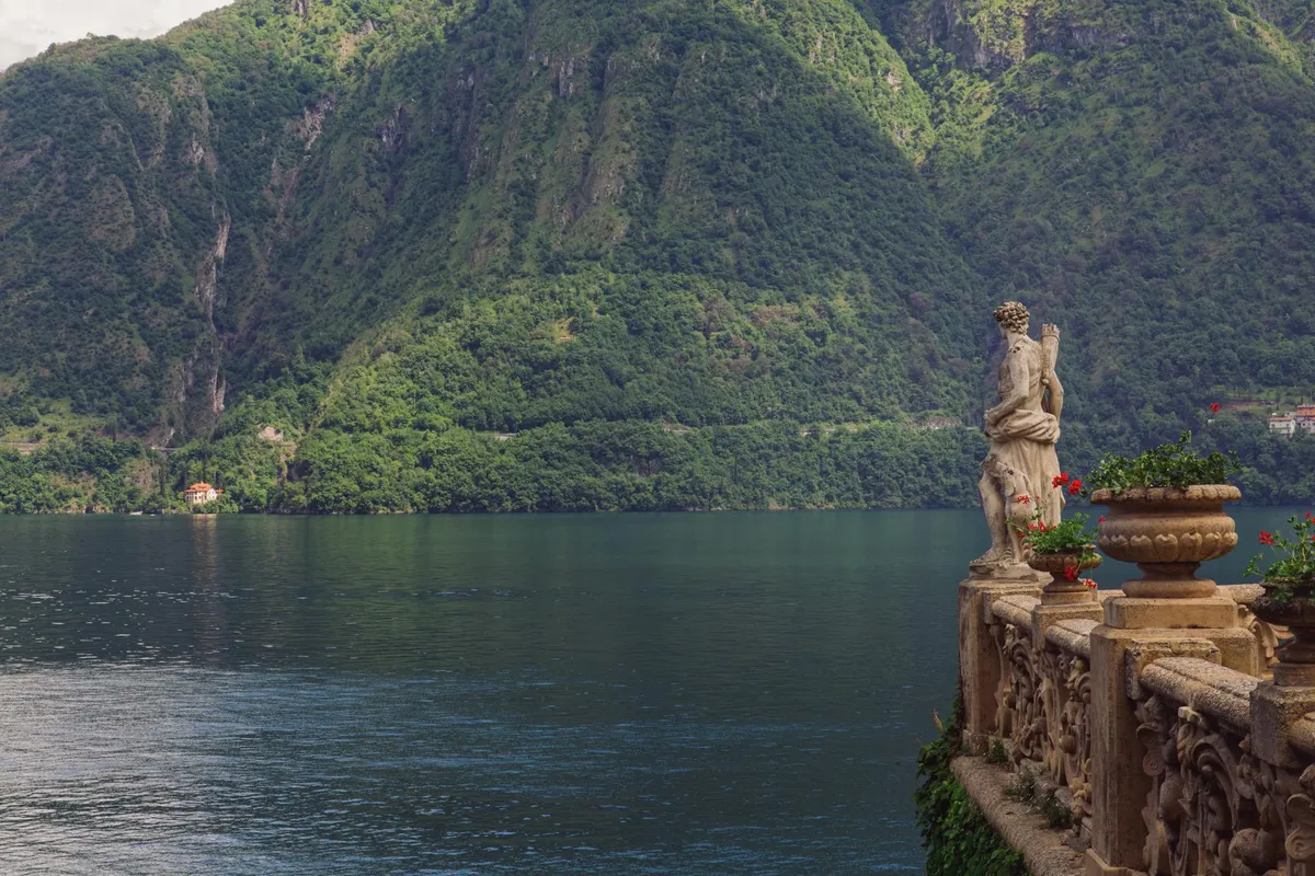 Picturesque view from Villa del Balbianello overlooking Lake Como and surrounding mountains.