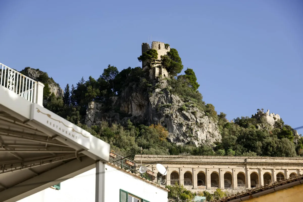 Charming Italian architecture nestled amidst the rugged cliffs of the Mediterranean coast.