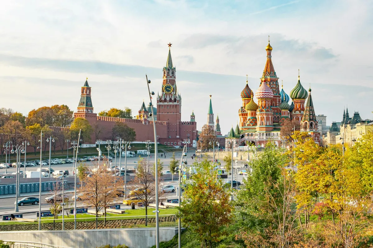 View of St. Basil's Cathedral and Kremlin during a sunny day in Moscow, Russia. Iconic tourist attraction.