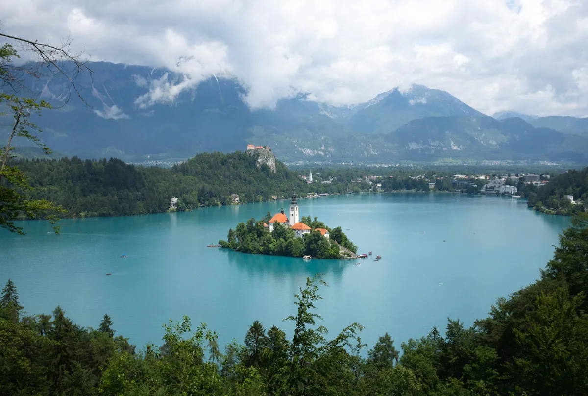 Stunning panoramic view of Lake Bled with its iconic island church and surrounding mountains.