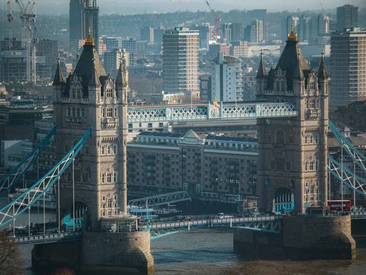 Aerial view of Tower Bridge with London's skyline in the background, capturing urban architecture.